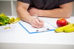 Trainer draws up a training program and a healthy diet plan